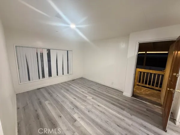 a view of a room with stairs and wooden floor