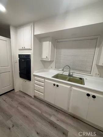 a kitchen with granite countertop a sink and cabinets