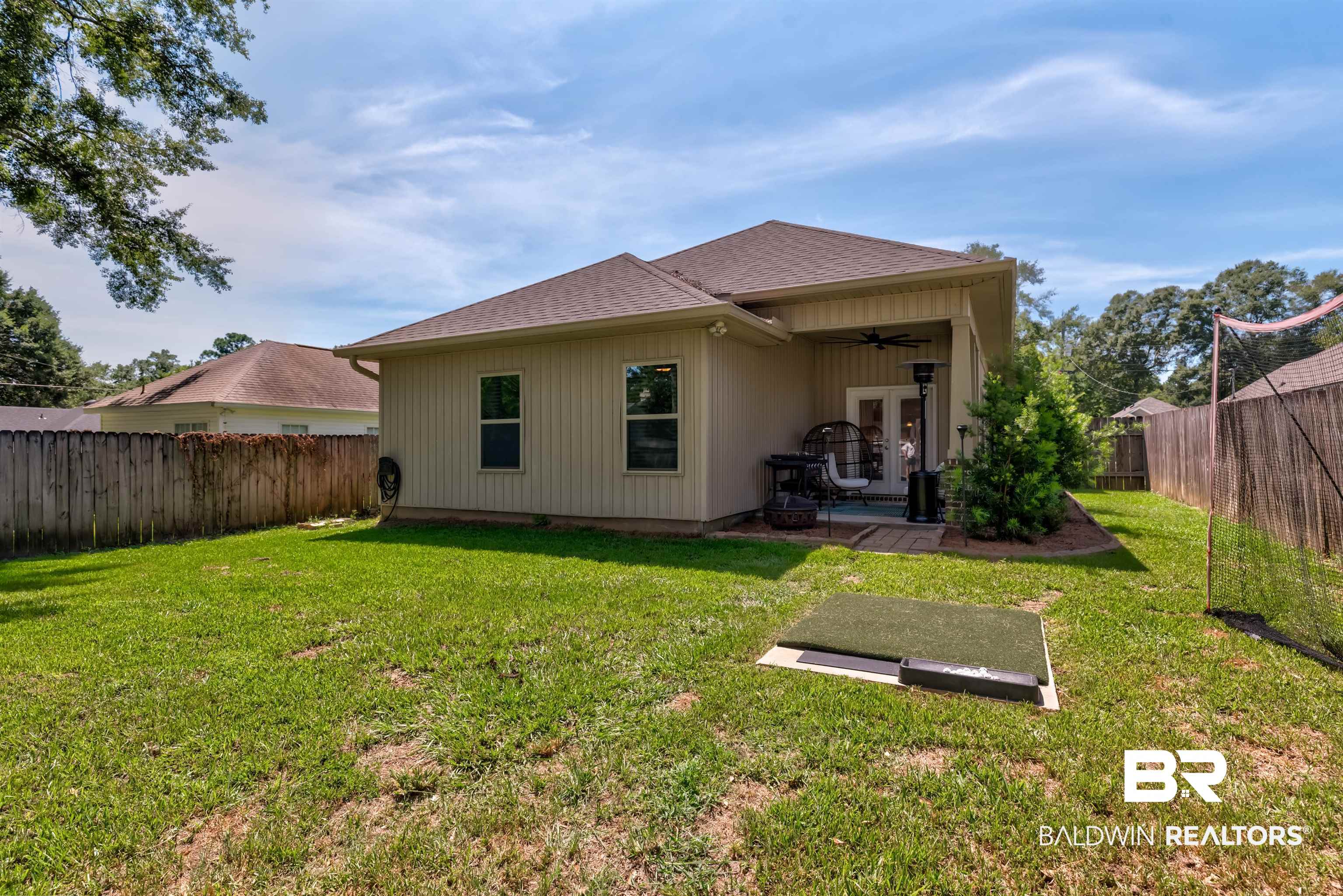 965 Henckley Avenue Mobile, AL 36609 - Photo 28 of 30 Back of house featuring ceiling fan, a patio area, and a yard