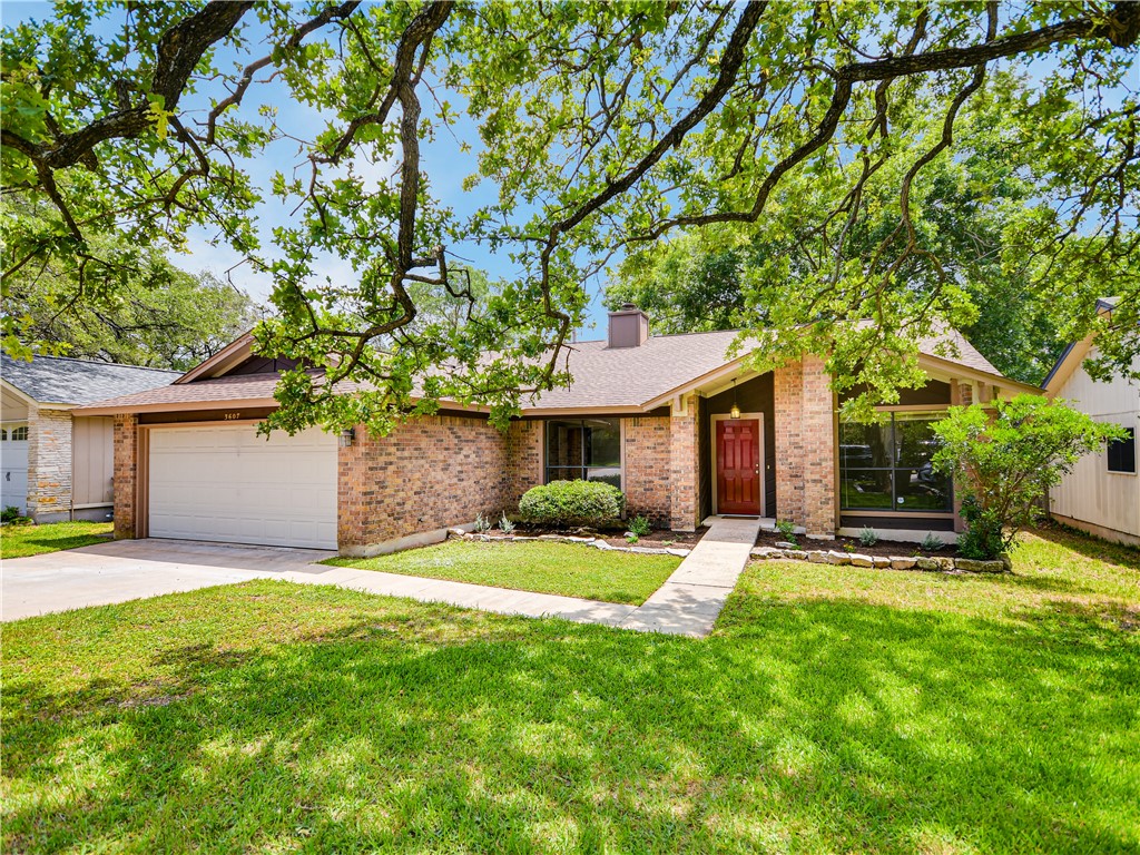 a front view of a house with a yard and trees