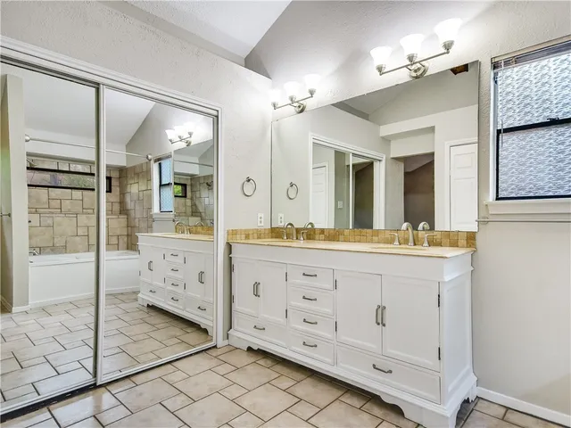 a bathroom with a sink mirror and double