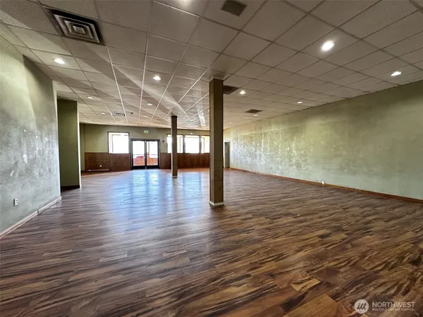 a view of an empty room with wooden floor
