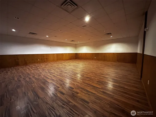 a view of a room with wooden floor