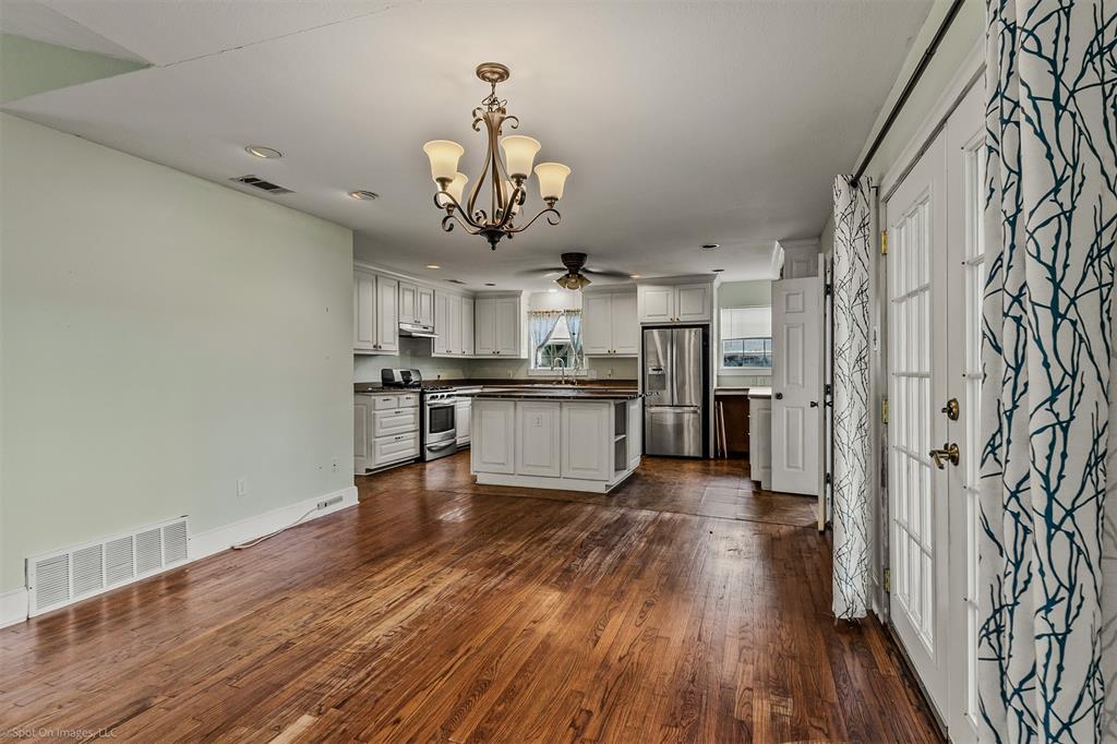 914 Griffith Avenue Terrell, TX 75160 - Photo 11 of 32 a view of a kitchen with a counter space stainless steel appliances and wooden floor