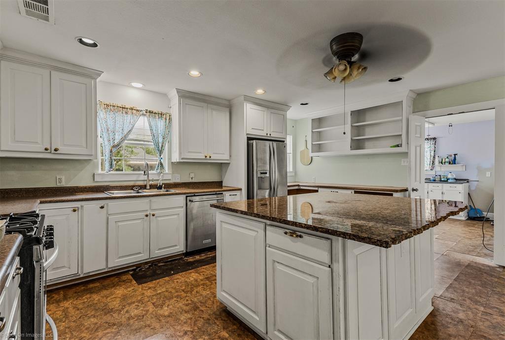 914 Griffith Avenue Terrell, TX 75160 - Photo 12 of 32 a kitchen with a center island appliances and cabinets