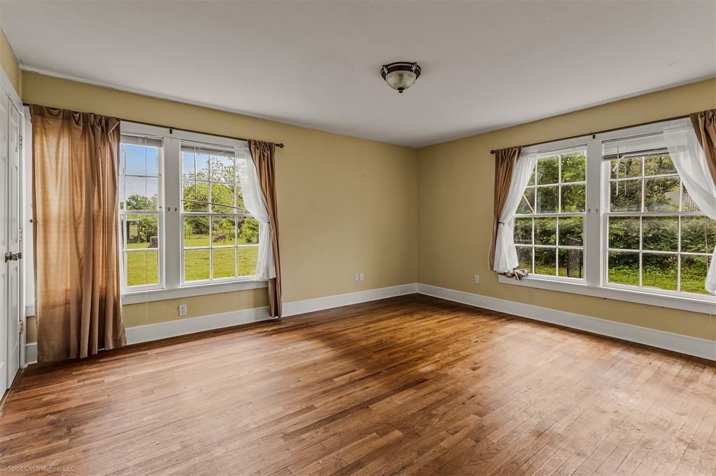 914 Griffith Avenue Terrell, TX 75160 - Photo 15 of 32 a view of an empty room with a window and wooden floor