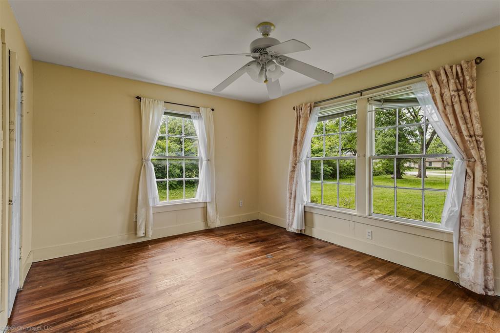 914 Griffith Avenue Terrell, TX 75160 - Photo 19 of 32 a view of an empty room with a window and wooden floor