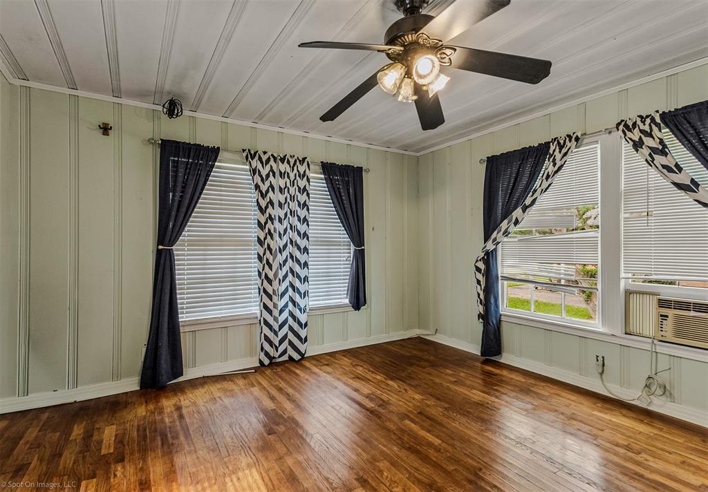914 Griffith Avenue Terrell, TX 75160 - Photo 21 of 32 en empty room with wooden floor fan and windows