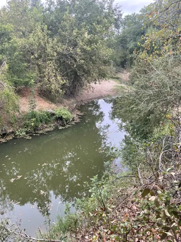 an aerial view of a house with a yard and lake view