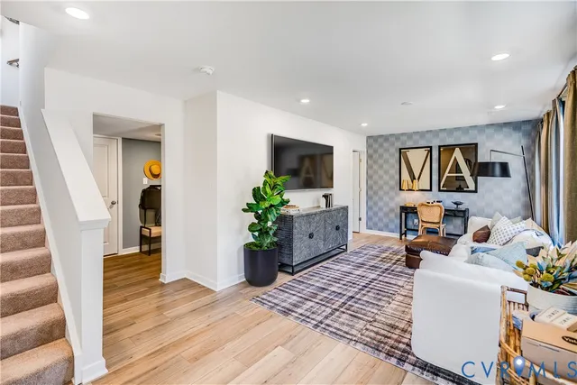 a living room with furniture and a flat screen tv