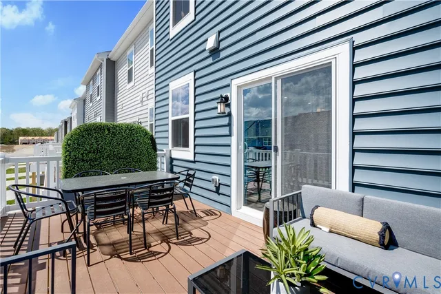 a outdoor living space with patio furniture and wooden floor