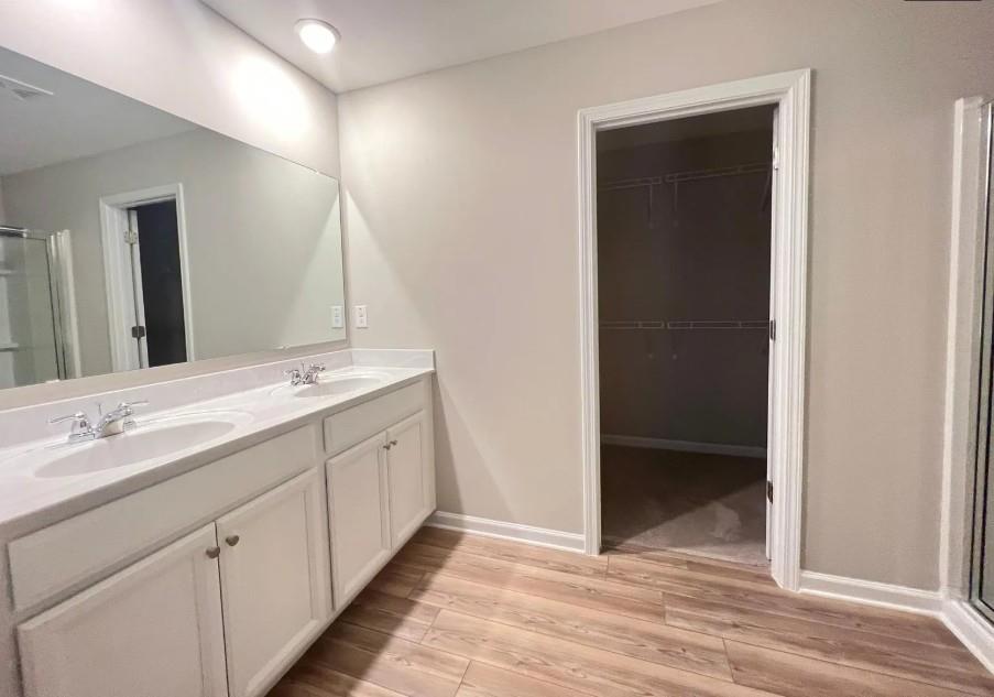 140 Golden Eagle Parkway Braselton, GA 30517 - Photo 9 of 13 a spacious bathroom with a double vanity sink and a mirror