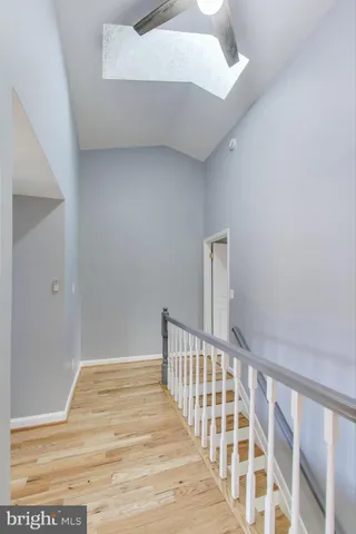 a view of a hallway with wooden floor and entryway