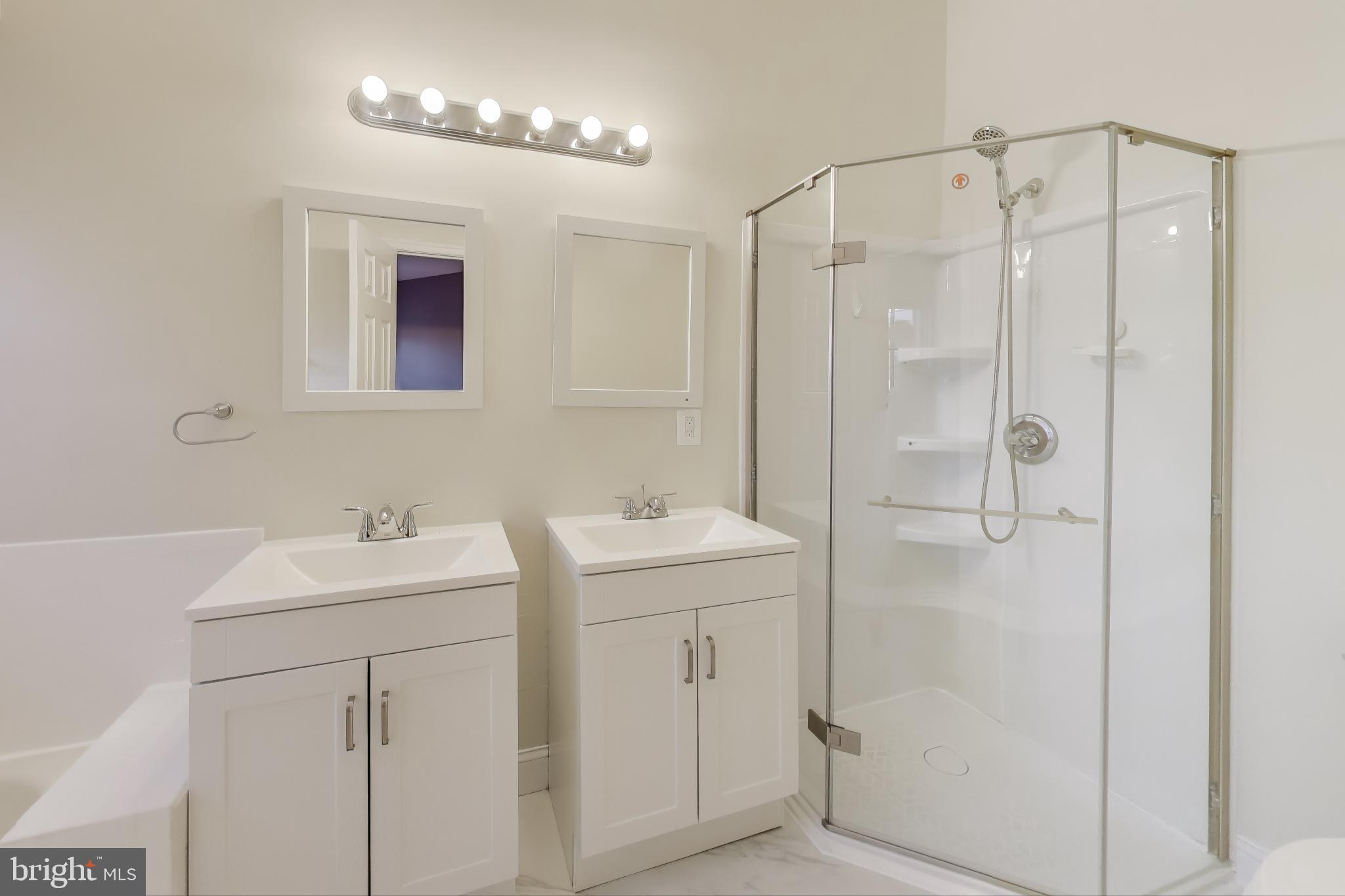 2851 Strauss Terrace Silver Spring, MD 20904 - Photo 17 of 34 a bathroom with a sink mirror and shower