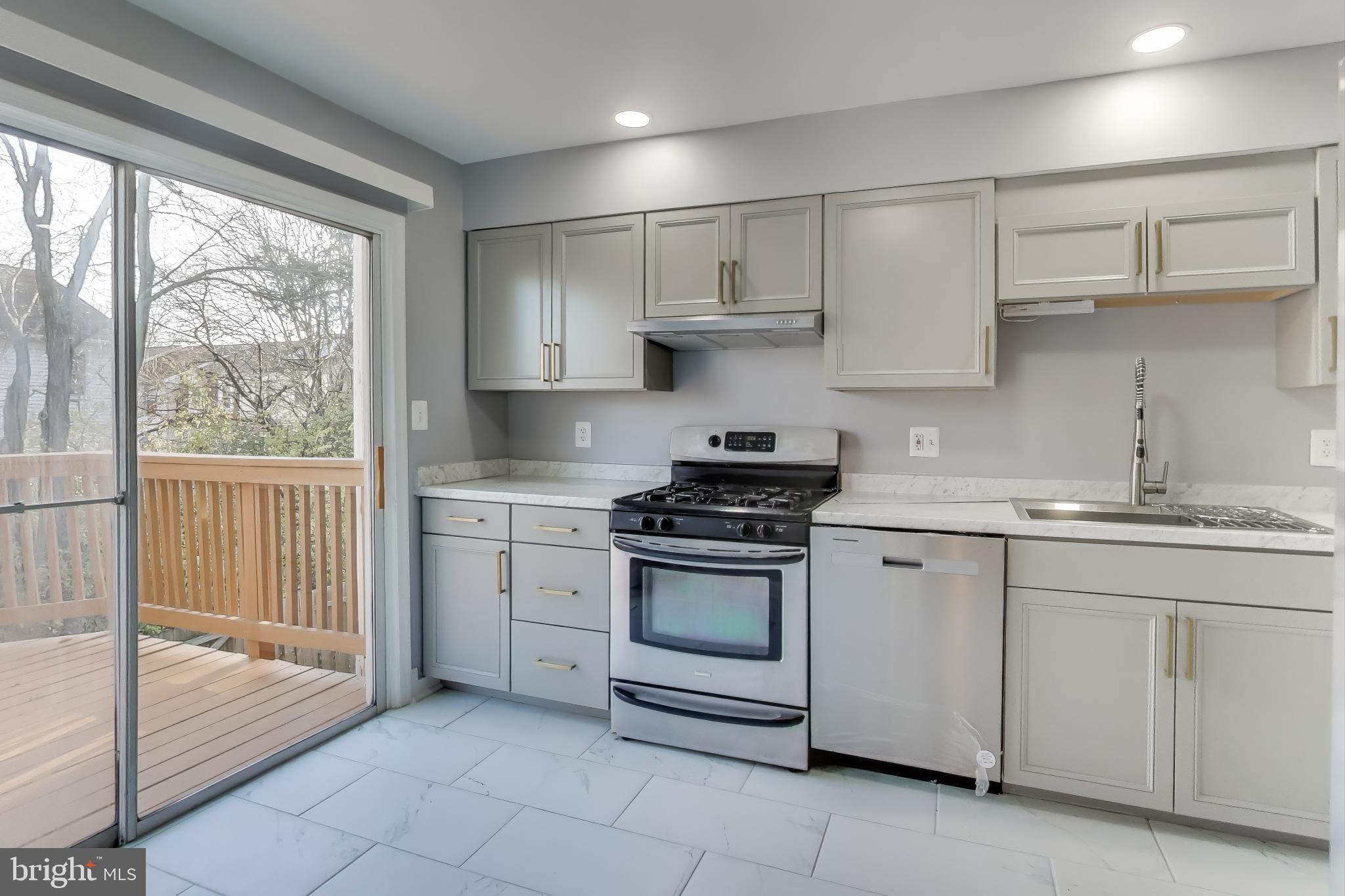 2851 Strauss Terrace Silver Spring, MD 20904 - Photo 2 of 34 a kitchen with white cabinets appliances and a sink