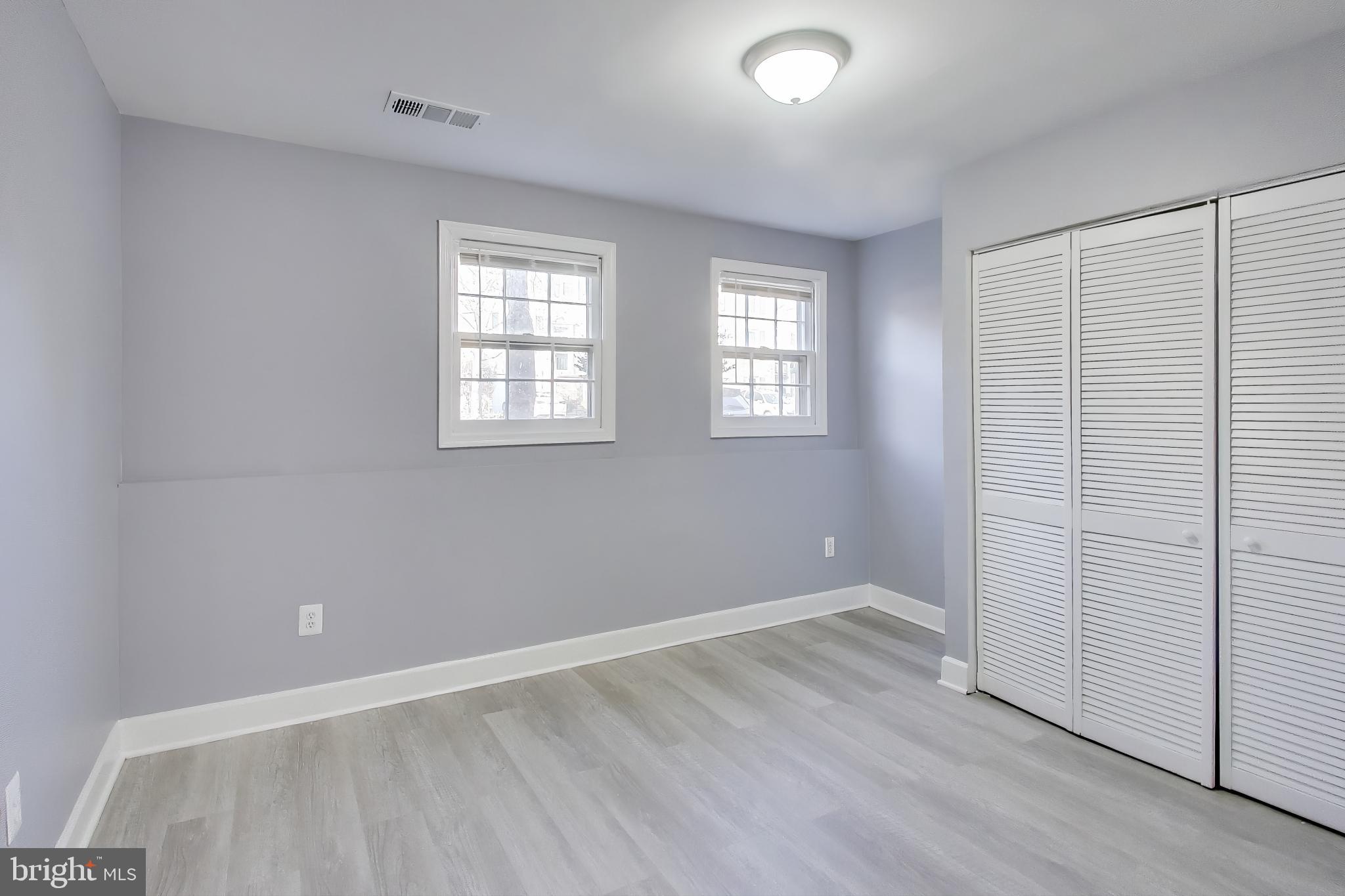 2851 Strauss Terrace Silver Spring, MD 20904 - Photo 27 of 34 an empty room with wooden floor and windows