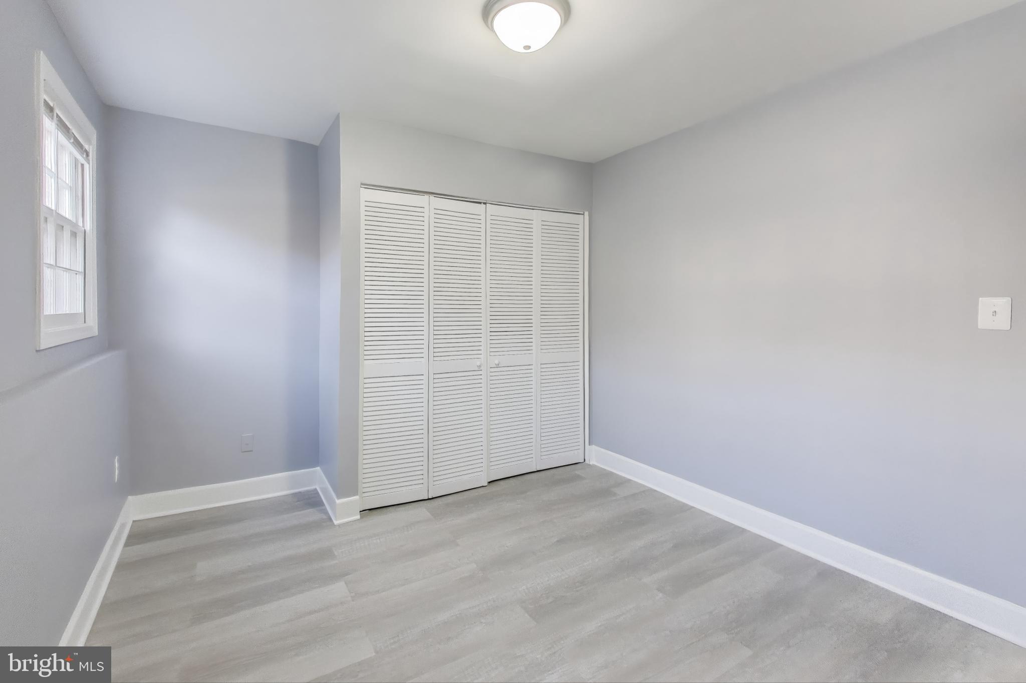 2851 Strauss Terrace Silver Spring, MD 20904 - Photo 28 of 34 an empty room with wooden floor and windows
