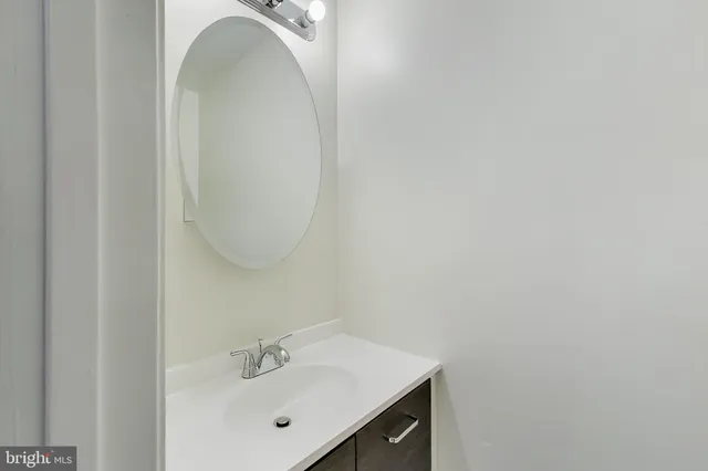 a bathroom with a sink and mirror