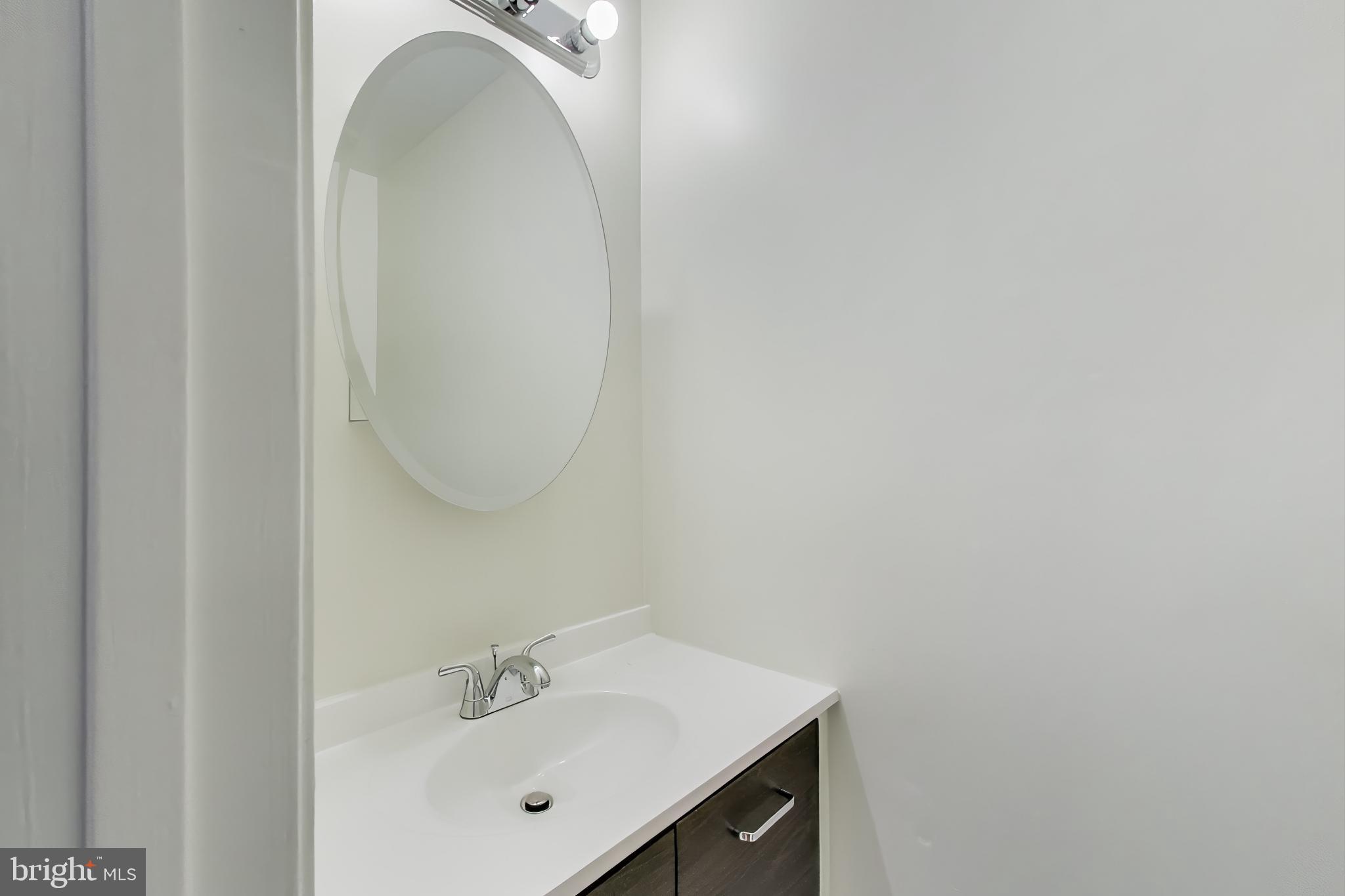 2851 Strauss Terrace Silver Spring, MD 20904 - Photo 10 of 34 a bathroom with a sink and mirror