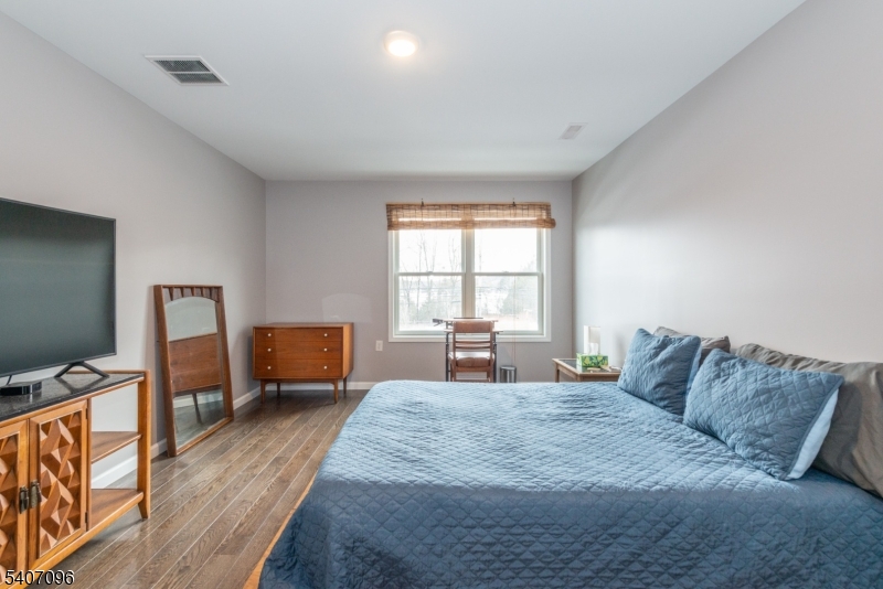 165 Lakeside Road West Milford, NJ 07421 - Photo 13 of 25 a large bedroom with a bed and wooden floor