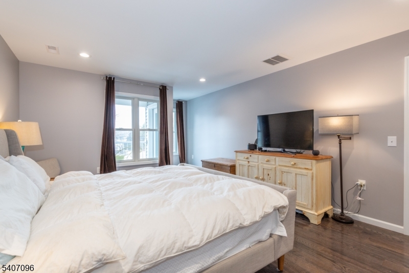 165 Lakeside Road West Milford, NJ 07421 - Photo 17 of 25 a bedroom with a bed and a flat screen tv