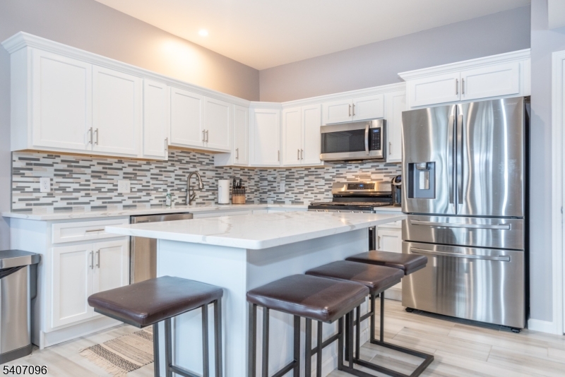 165 Lakeside Road West Milford, NJ 07421 - Photo 2 of 25 a kitchen with cabinets stainless steel appliances and a center island