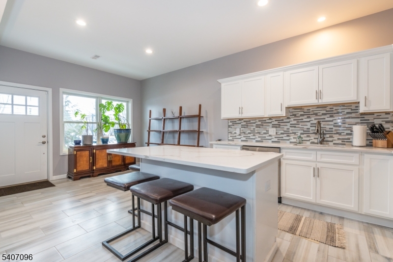 165 Lakeside Road West Milford, NJ 07421 - Photo 4 of 25 a kitchen with granite countertop white cabinets and white appliances