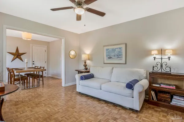 a living room with furniture a clock and a window