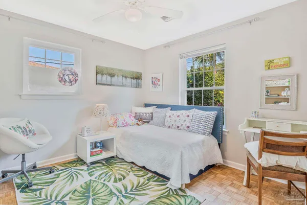 a bedroom with a bed and a workspace