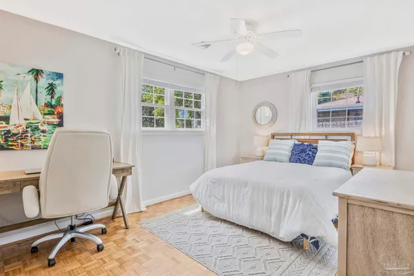 a bedroom with a bed and a desk