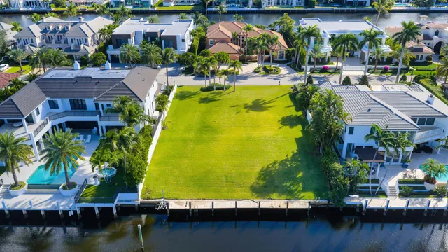 an aerial view of residential houses with outdoor space and swimming pool