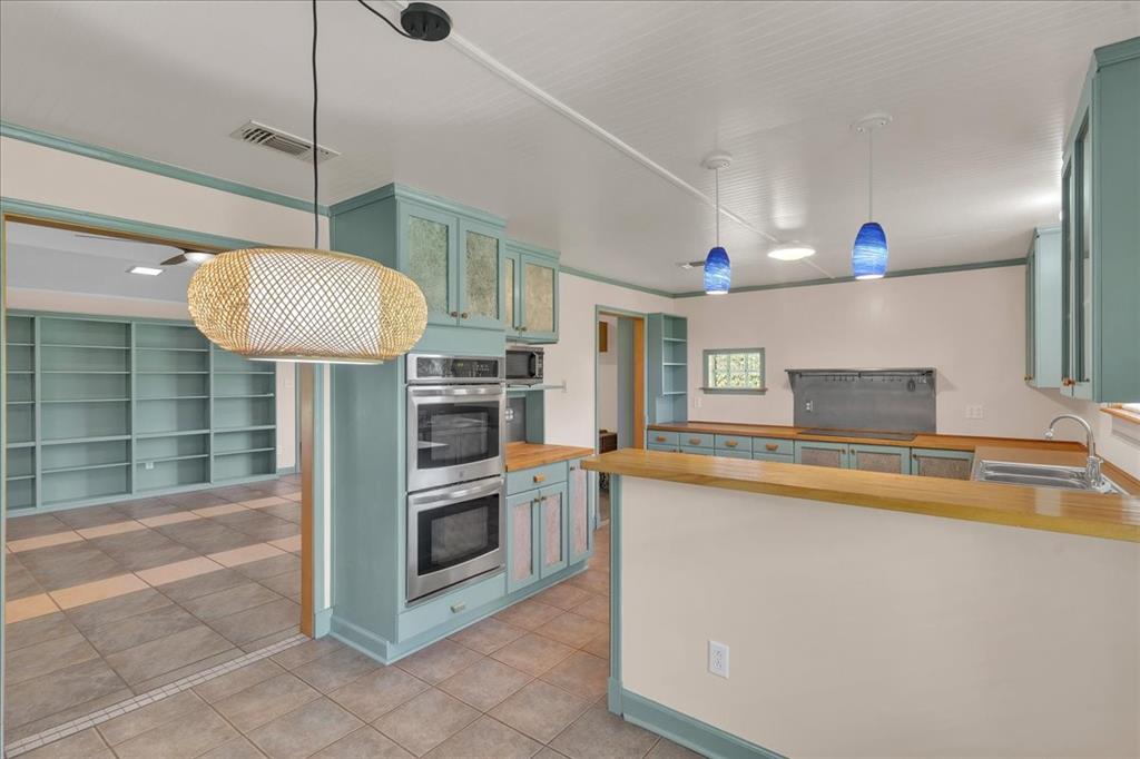 1900 South Duncanville Road Red Oak, TX 75154 - Photo 11 of 39 Kitchen features double ovens and stainless steel appliances.