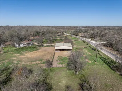 an aerial view of a houses with a yard