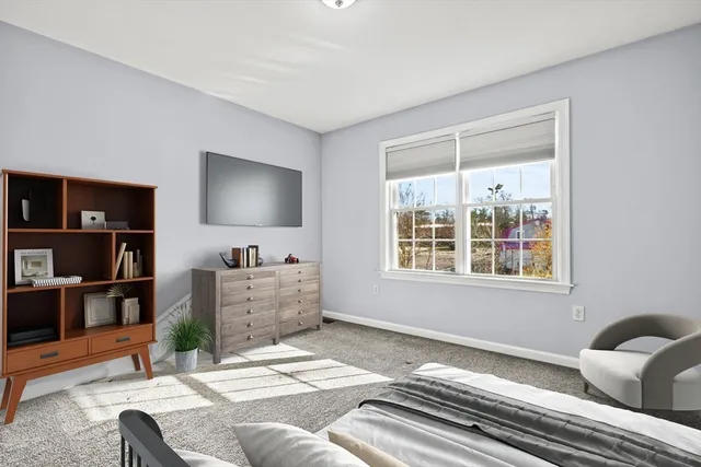 a bedroom with furniture and a flat screen tv