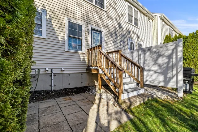 a view of an house with backyard and sitting area
