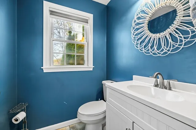 a bathroom with a toilet a sink and mirror