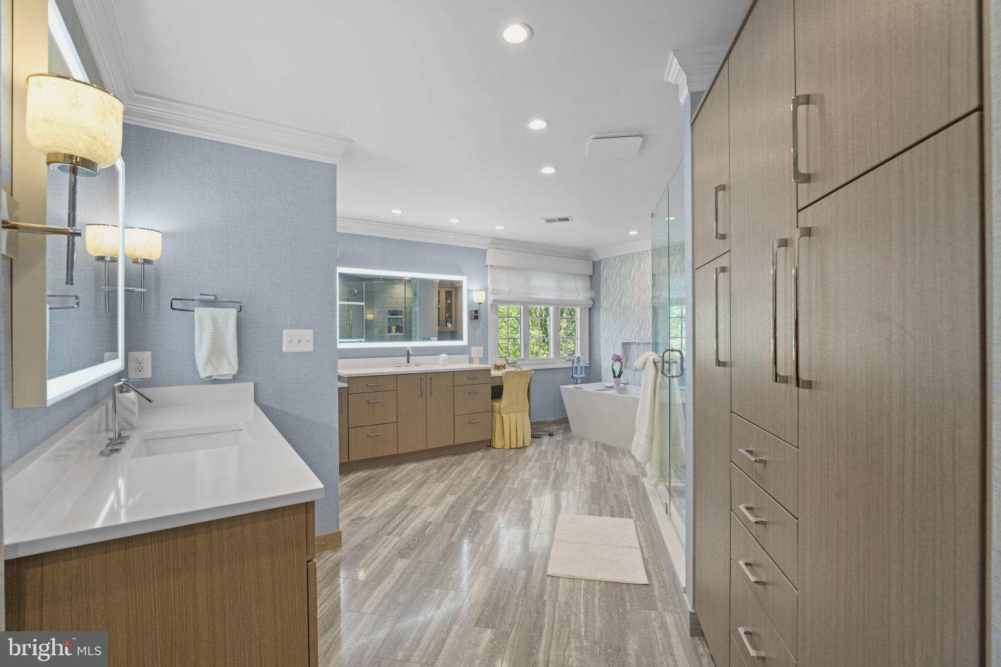 11431 Woolington Road Great Falls, VA 22066 - Photo 25 of 49 a large white kitchen with a lot of counter space and wooden floor