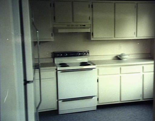 7 Padanaram Road, Unit 76 Danbury, CT 06811 - Photo 1 of 1 a kitchen with cabinets and a stove