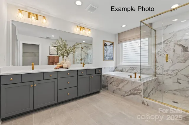 a spacious bathroom with double vanity a mirror a bathtub and a shower