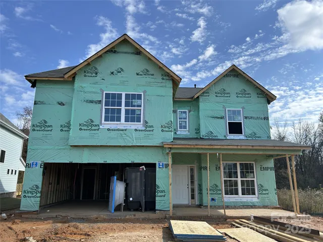a front view of a house with a garden and garage