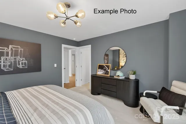 a bedroom with a bed couch and windows