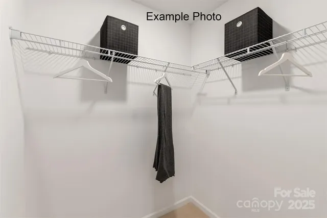 a view of a room with wooden floor and windows
