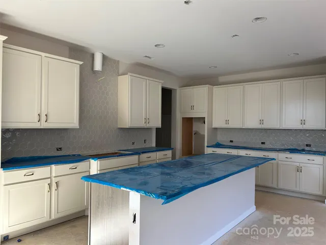 a kitchen with granite countertop a sink and cabinets