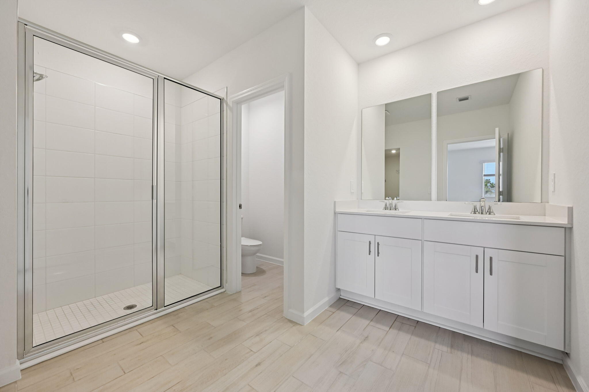 14211 Southwest New Dawn Road Indiantown, FL 34956 - Photo 17 of 37 a spacious bathroom with a shower sink and mirror