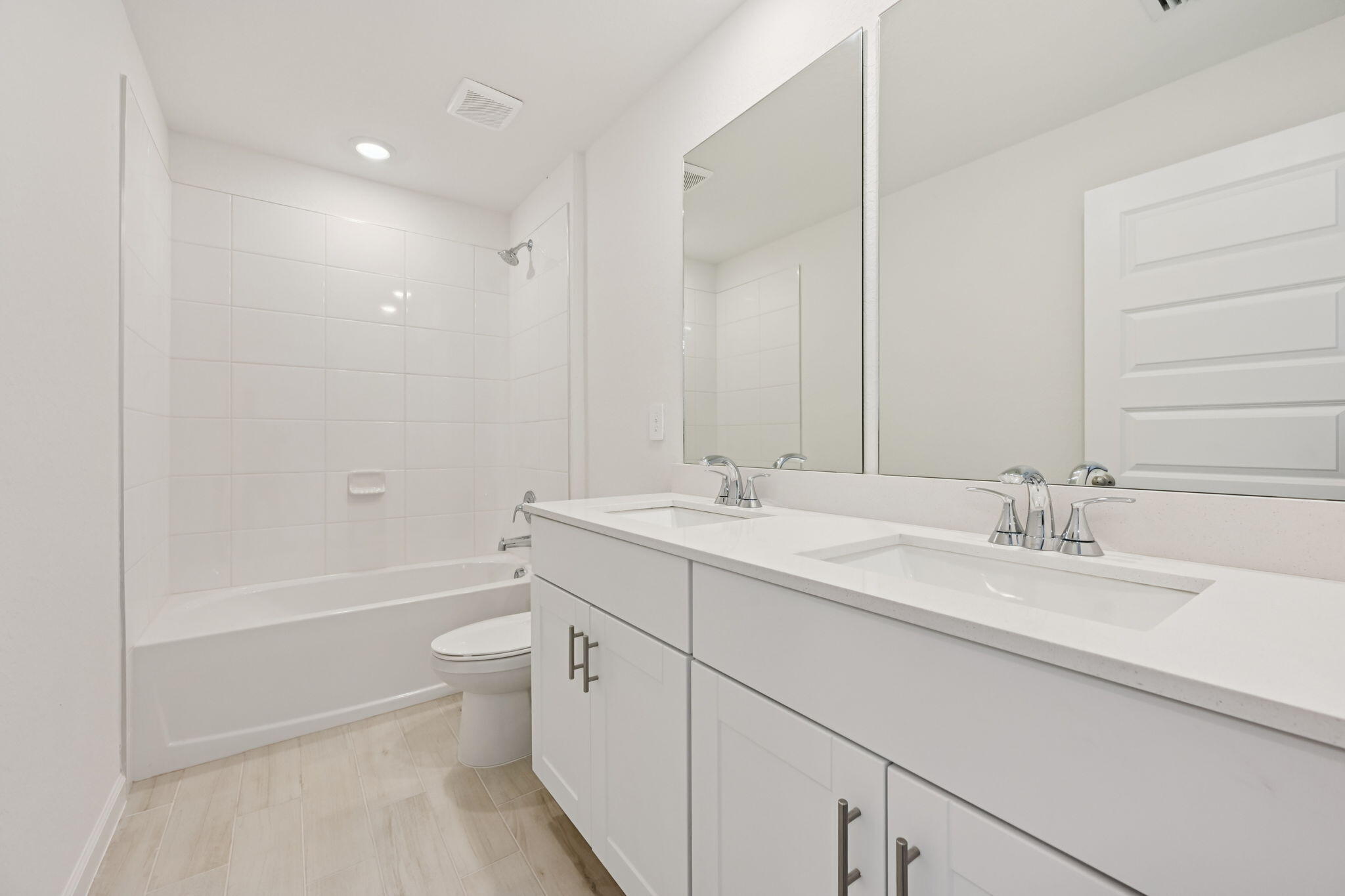 14211 Southwest New Dawn Road Indiantown, FL 34956 - Photo 23 of 37 a bathroom with a double vanity sink toilet mirror and bathtub