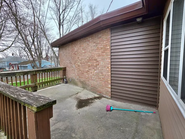 a view of a porch with a table and chair
