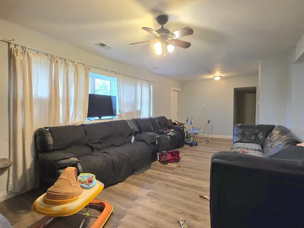 a living room with furniture and a chandelier