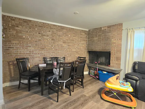 a dining room with furniture wooden floor and a fireplace