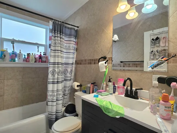 a bathroom with a sink toilet and shower