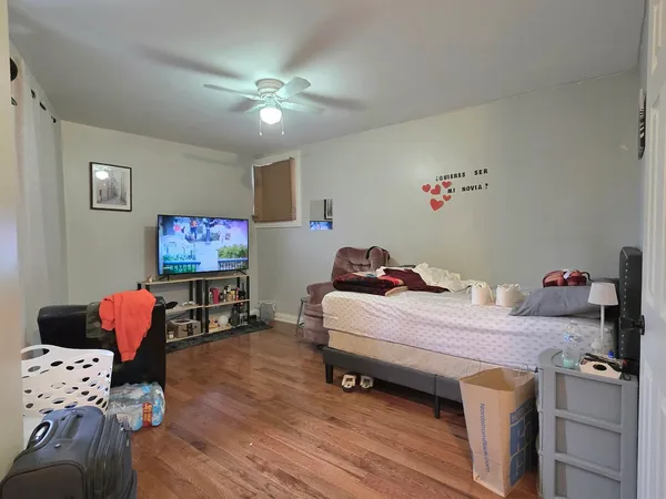a bedroom with furniture and a wooden floor